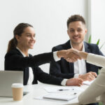 HR representatives positively greeting female job candidate